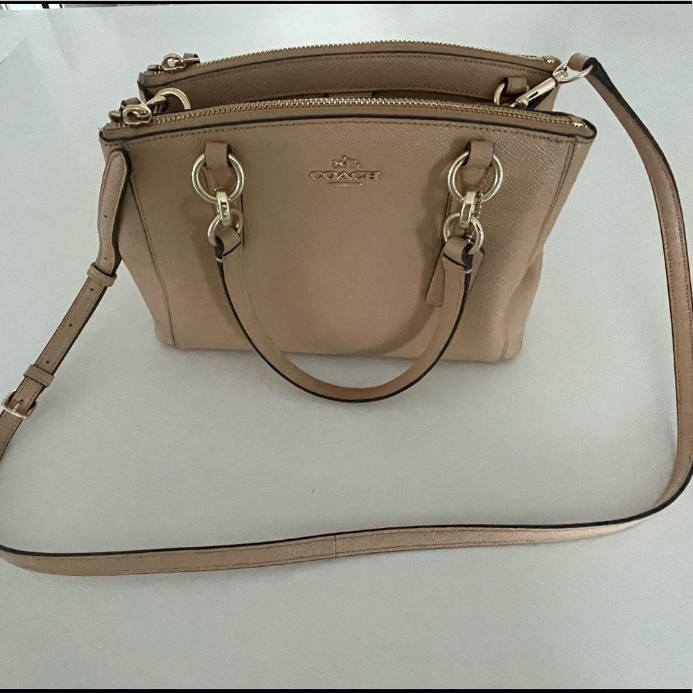 Coach khaki bag. Three pockets. Adjustable shoulder strap or handle. Gold accent